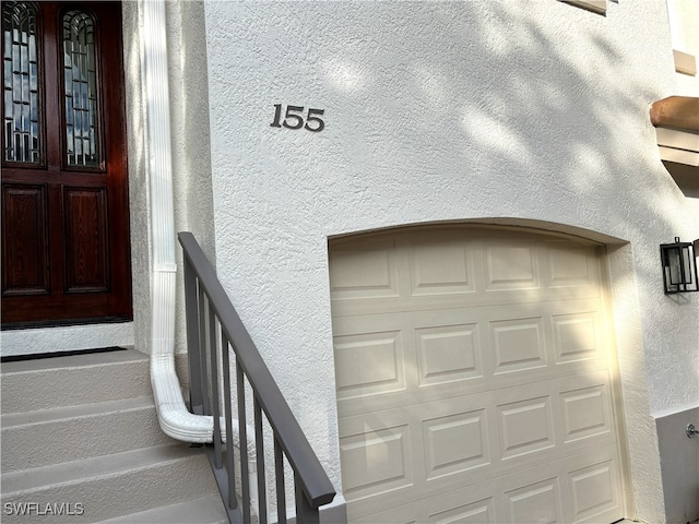 property entrance featuring stucco siding