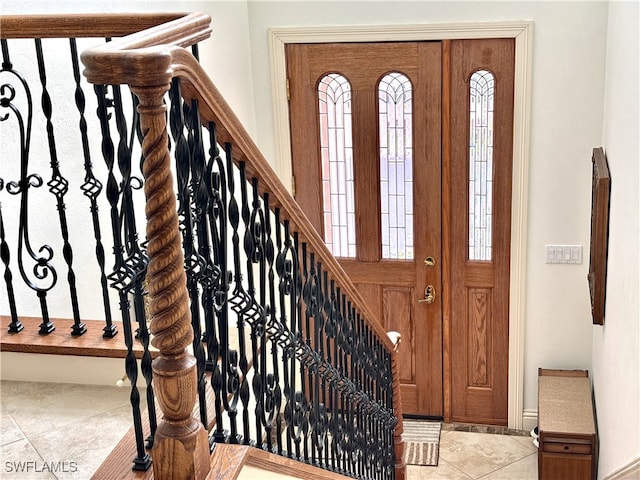 entrance foyer with tile patterned flooring and stairway