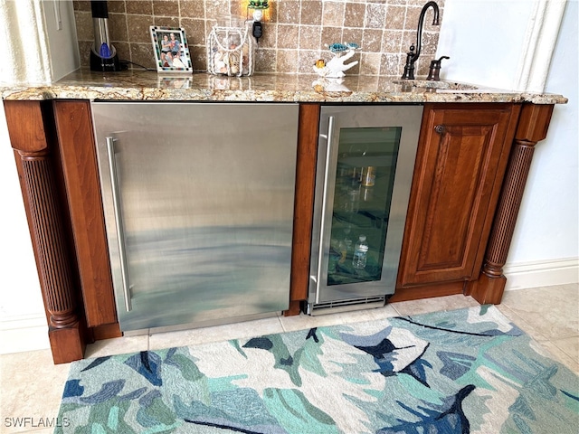 bar featuring wine cooler, tile patterned flooring, a sink, decorative backsplash, and indoor wet bar