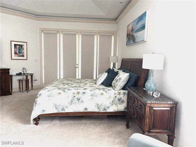 bedroom with crown molding, a closet, and light colored carpet