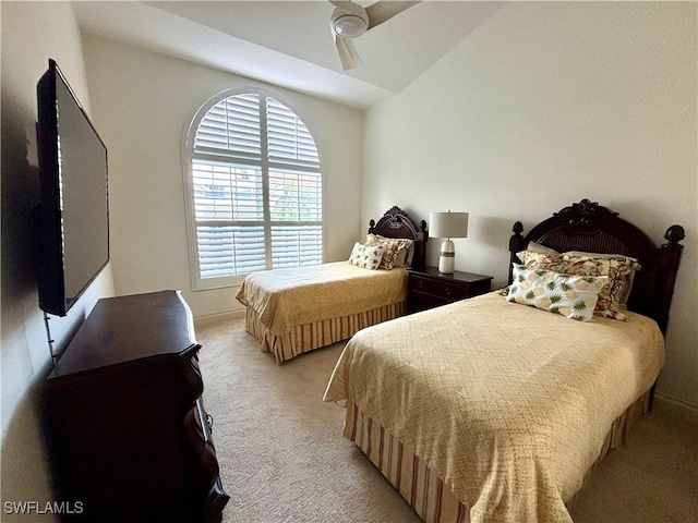 bedroom featuring light carpet, ceiling fan, and vaulted ceiling