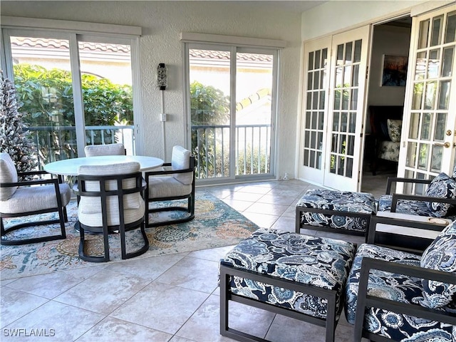 sunroom with a healthy amount of sunlight and french doors