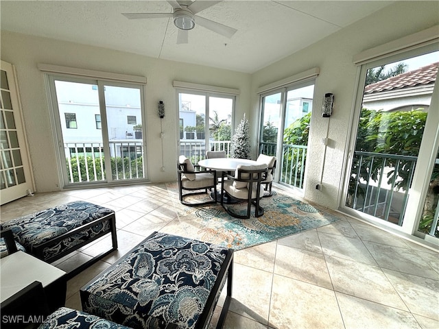 sunroom / solarium featuring a ceiling fan