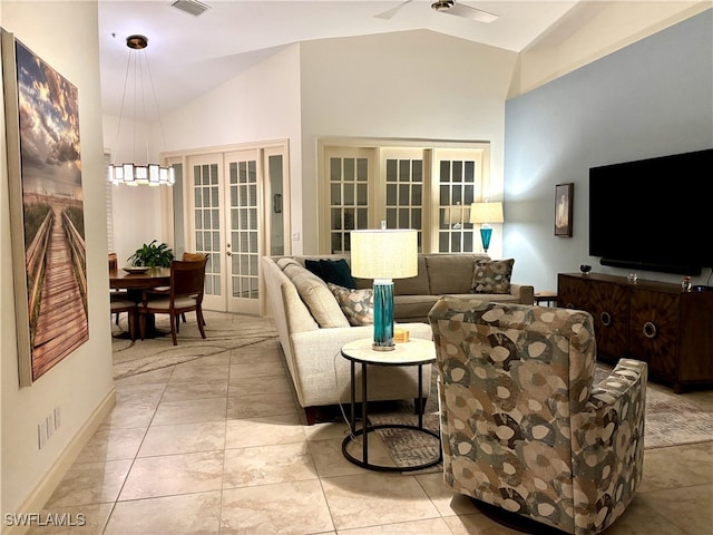 living room featuring lofted ceiling, ceiling fan, light tile patterned flooring, visible vents, and french doors