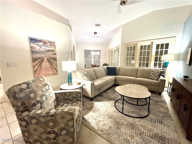 tiled living area with a ceiling fan, lofted ceiling, and visible vents