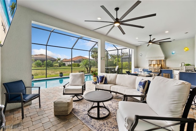 view of patio featuring grilling area, an outdoor hangout area, glass enclosure, and an outdoor kitchen