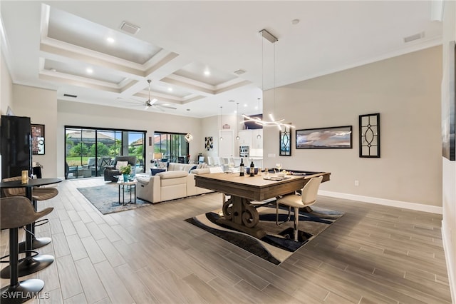 dining space featuring beamed ceiling, a high ceiling, coffered ceiling, ceiling fan, and crown molding