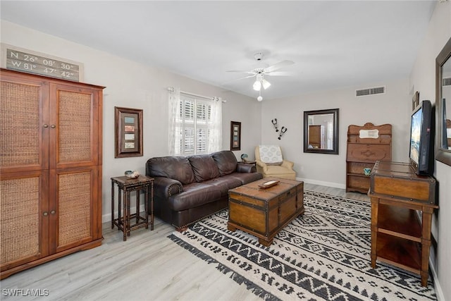 living room with ceiling fan and light hardwood / wood-style floors