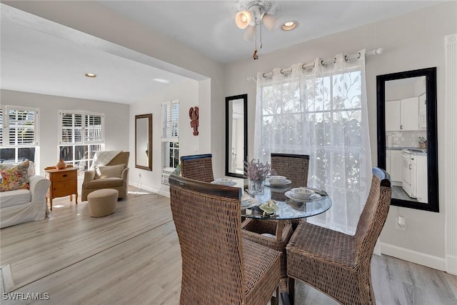 dining space featuring light wood-type flooring and ceiling fan