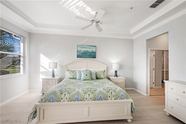 bedroom featuring crown molding, light hardwood / wood-style floors, and ceiling fan