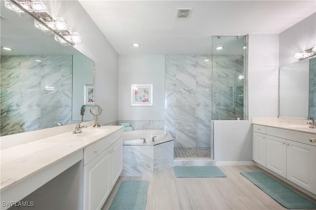 bathroom featuring vanity and separate shower and tub