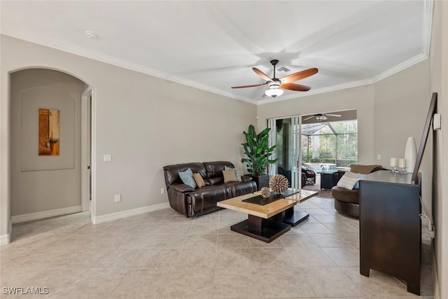 tiled living room with ceiling fan and ornamental molding