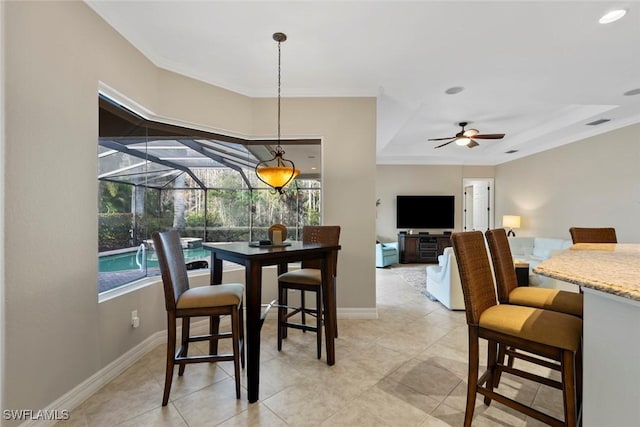 tiled dining room featuring ceiling fan and ornamental molding