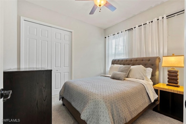 bedroom with a closet, carpet, and ceiling fan