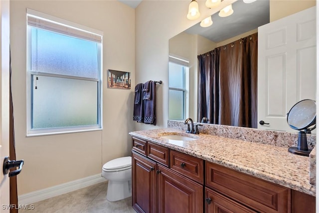 bathroom with toilet, tile patterned floors, and vanity