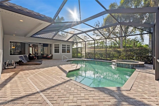 view of swimming pool with a lanai, a patio, and an in ground hot tub