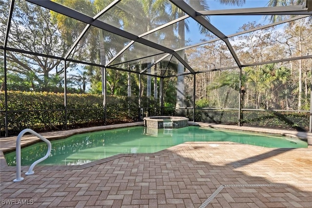 view of pool with an in ground hot tub, a patio area, and glass enclosure