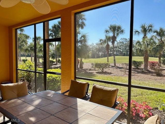 sunroom / solarium featuring plenty of natural light and ceiling fan