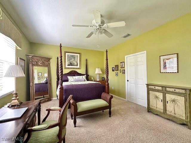 bedroom featuring ceiling fan and light carpet