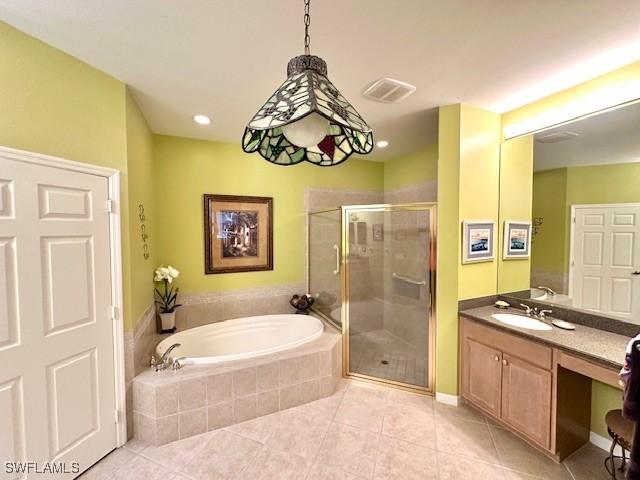 bathroom with tile patterned flooring, plus walk in shower, and vanity