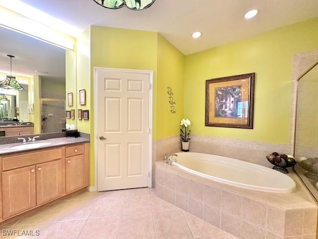 bathroom with vanity, shower with separate bathtub, and tile patterned floors