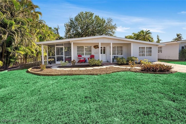 single story home with a front lawn and a sunroom