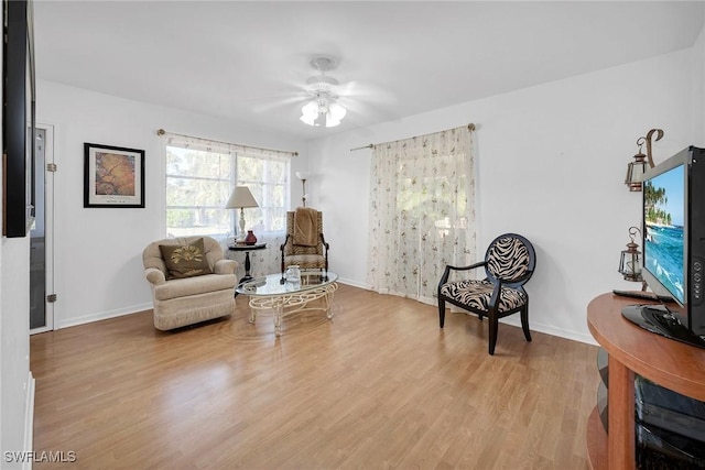 sitting room featuring ceiling fan and light wood-type flooring