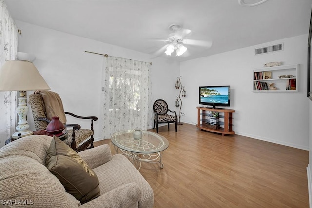 living room with ceiling fan and wood-type flooring