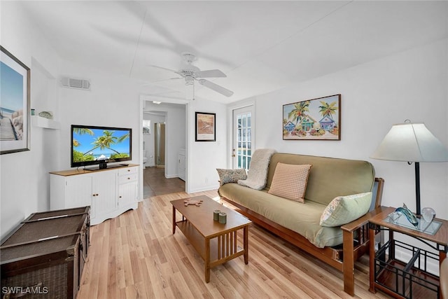 living room featuring ceiling fan and light hardwood / wood-style flooring