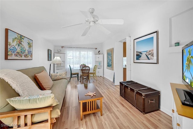 living room featuring ceiling fan and light hardwood / wood-style flooring