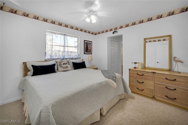 bedroom featuring ceiling fan and light carpet