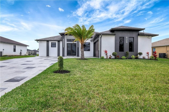 view of front of home with central AC unit and a front lawn