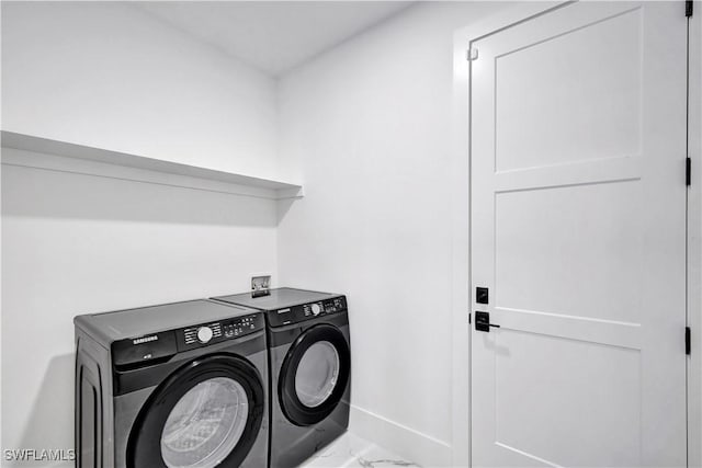 clothes washing area featuring washing machine and clothes dryer