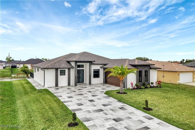 view of front of house with a garage and a front lawn