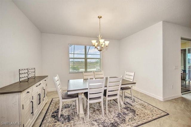 tiled dining room with an inviting chandelier