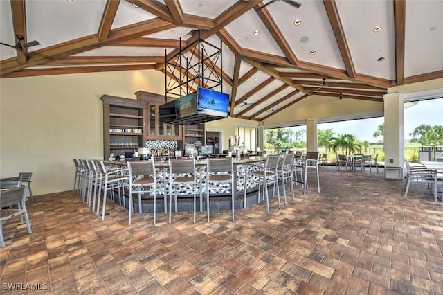 interior space with high vaulted ceiling and beamed ceiling