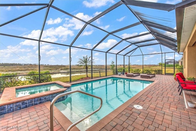 view of pool with a lanai, a patio, and an in ground hot tub