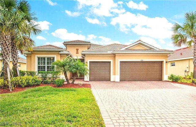 view of front of house with a garage and a front lawn