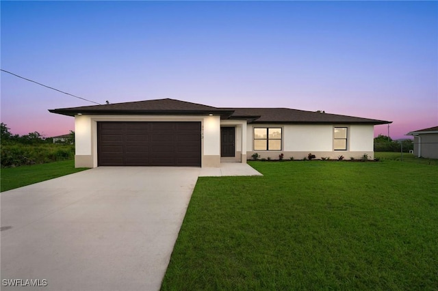 2606 71st St W, Lehigh Acres, FL 33971 - prairie-style home featuring a garage and a yard