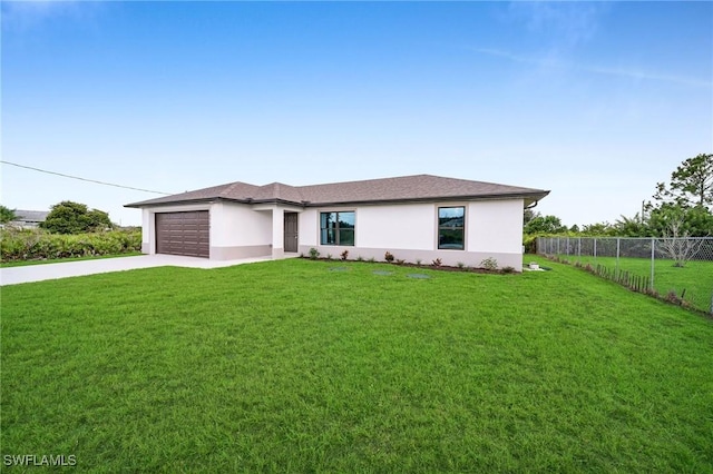 view of front of home with a front yard and a garage