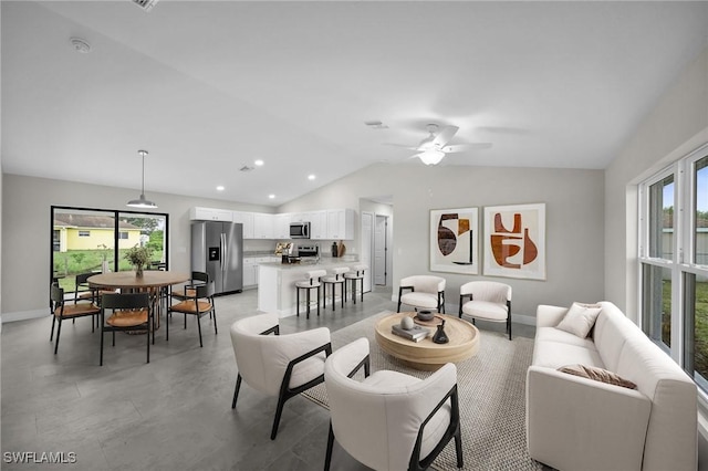 living room featuring vaulted ceiling and ceiling fan