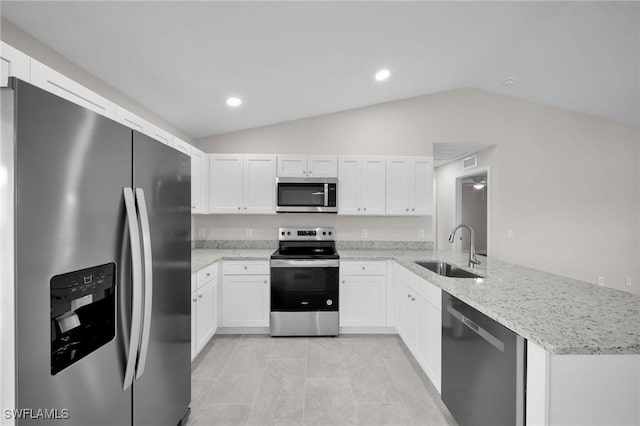 kitchen with white cabinets, lofted ceiling, stainless steel appliances, sink, and kitchen peninsula