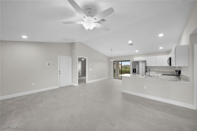 kitchen with ceiling fan, kitchen peninsula, white cabinetry, stainless steel fridge, and light stone counters