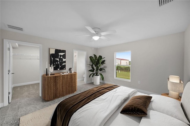 bedroom featuring ceiling fan, light colored carpet, and a closet