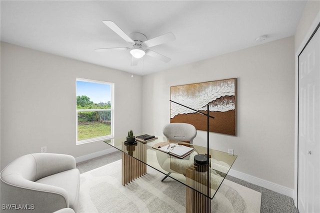 carpeted office with ceiling fan