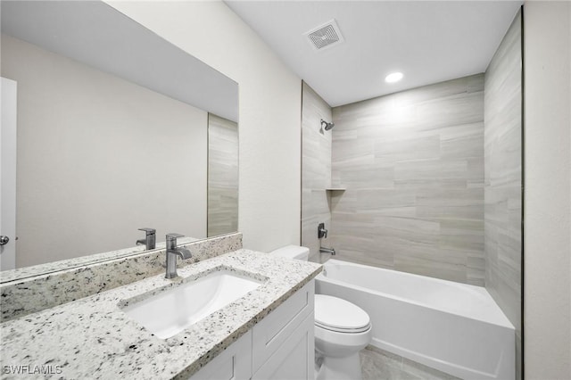 full bathroom with toilet, vanity, and tiled shower / bath