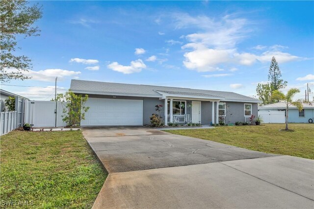 ranch-style home featuring a garage and a front yard