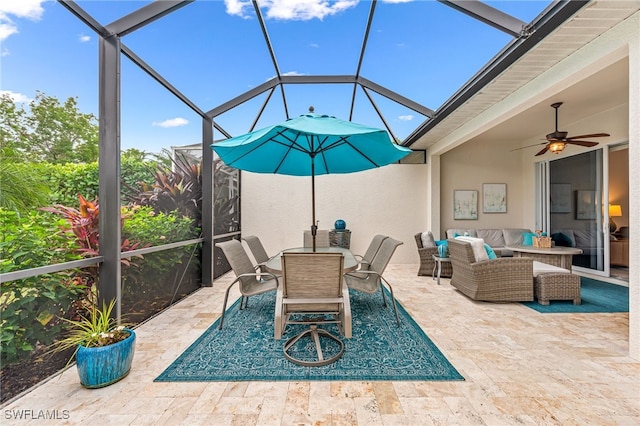 view of patio / terrace featuring ceiling fan, outdoor lounge area, and glass enclosure