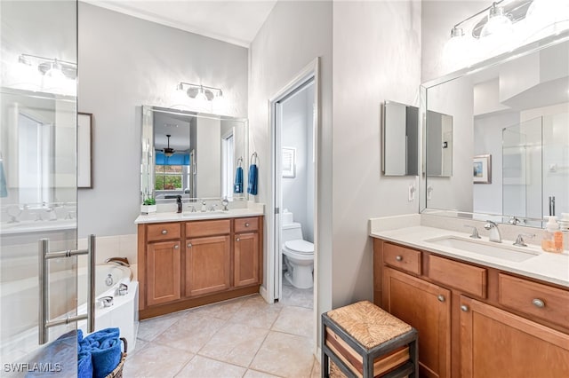 full bathroom with tile patterned floors, toilet, vanity, and shower with separate bathtub