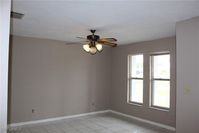 empty room featuring ceiling fan and light tile patterned floors